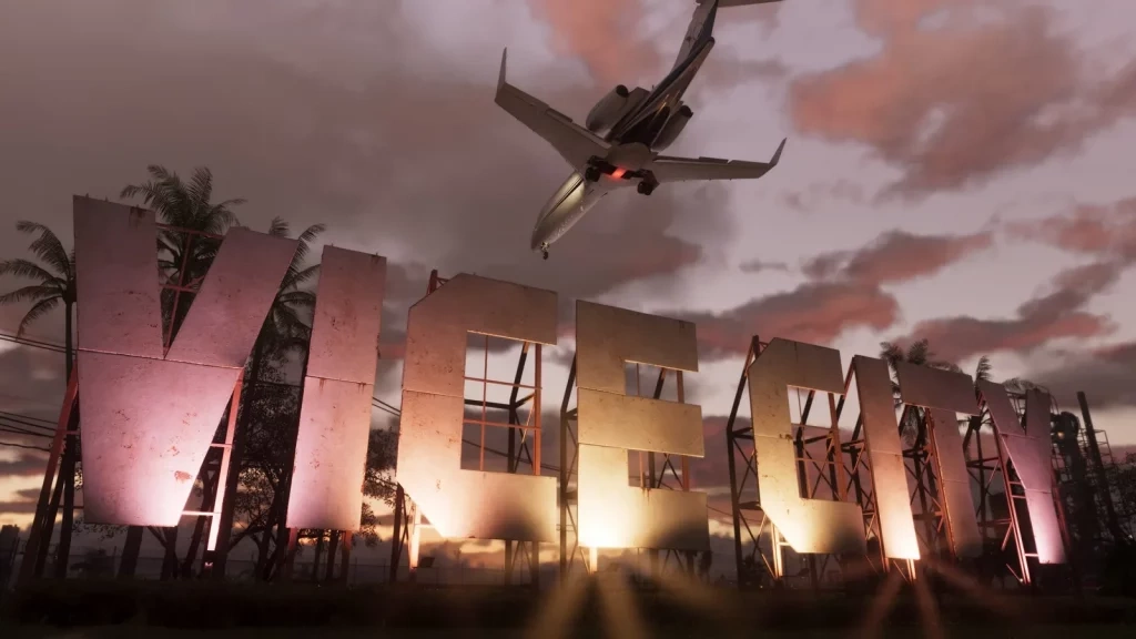 Огромные объёмные буквы VICE CITY на фоне розового закатного неба, над ними заходит на посадку самолёт